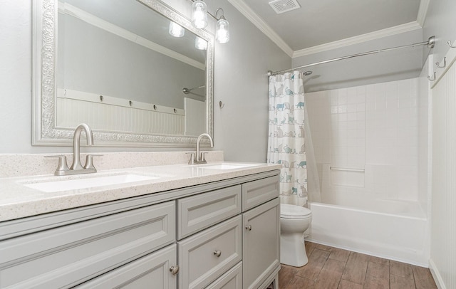 full bathroom featuring ornamental molding, vanity, shower / bathtub combination with curtain, and toilet