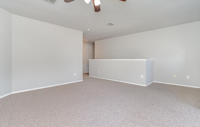 spare room featuring baseboards, a ceiling fan, and carpet flooring