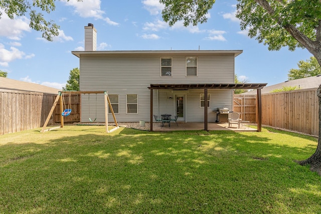 back of property with a yard, a fenced backyard, and a patio