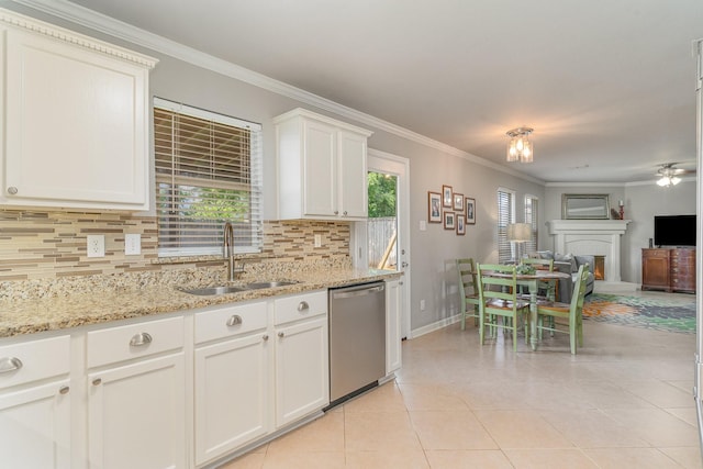 kitchen with sink, light tile patterned floors, white cabinetry, tasteful backsplash, and stainless steel dishwasher