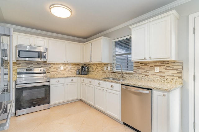 kitchen featuring a sink, white cabinetry, ornamental molding, appliances with stainless steel finishes, and backsplash