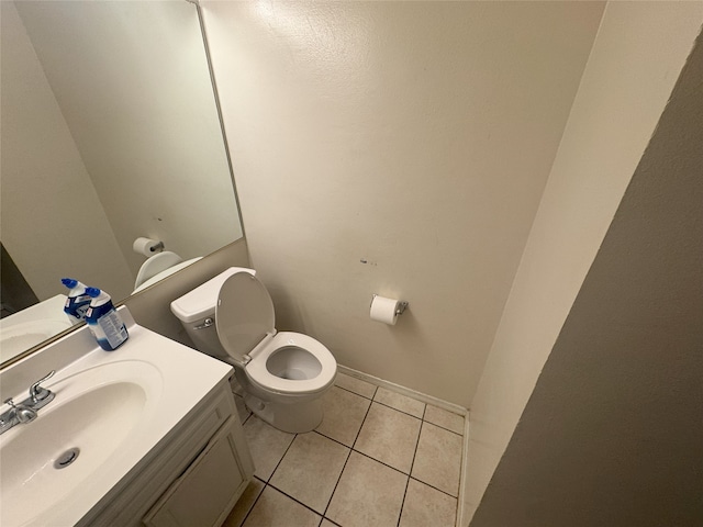 bathroom featuring vanity, tile patterned floors, and toilet