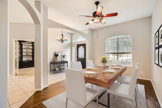 dining space featuring hardwood / wood-style floors and ceiling fan with notable chandelier