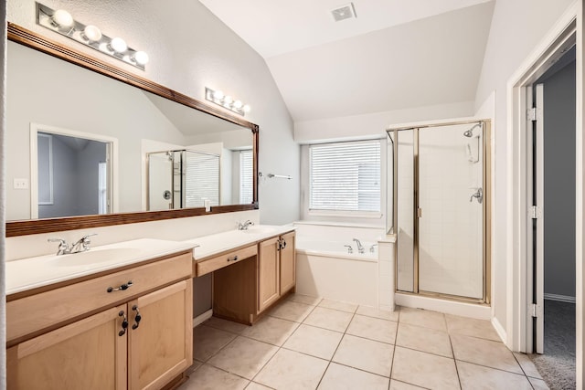 bathroom with plus walk in shower, tile patterned flooring, vanity, and lofted ceiling