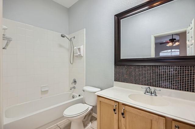 full bathroom featuring tile patterned floors, vanity, toilet, and tiled shower / bath