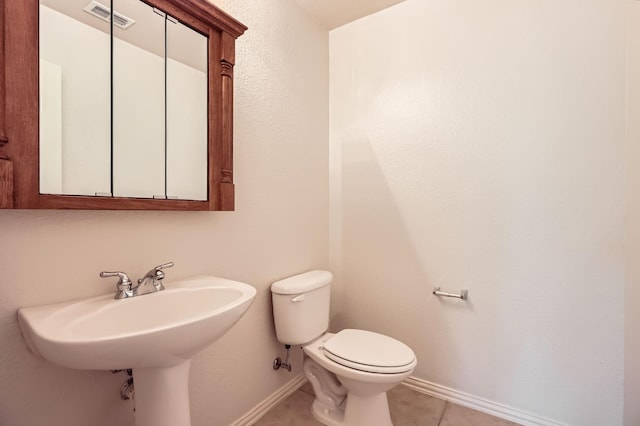 bathroom with tile patterned flooring and toilet