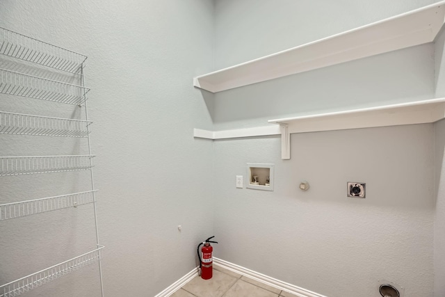 clothes washing area with gas dryer hookup, hookup for a washing machine, electric dryer hookup, and light tile patterned floors