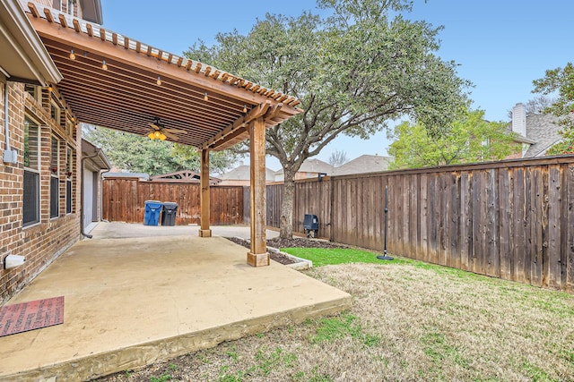 view of yard featuring ceiling fan and a patio area