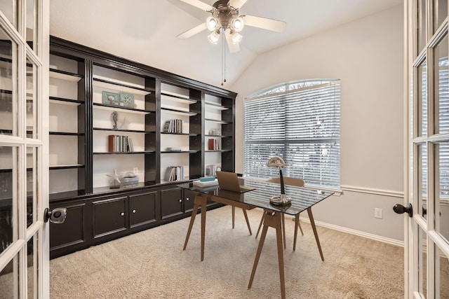 carpeted office space featuring french doors, vaulted ceiling, and ceiling fan