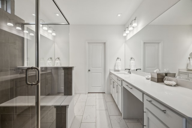 bathroom with vanity and a shower with shower door