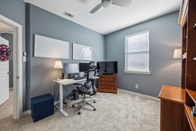 carpeted office space featuring ceiling fan