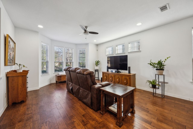 living room with ceiling fan and dark hardwood / wood-style flooring