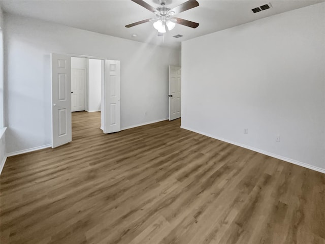 unfurnished bedroom with dark wood-type flooring and ceiling fan