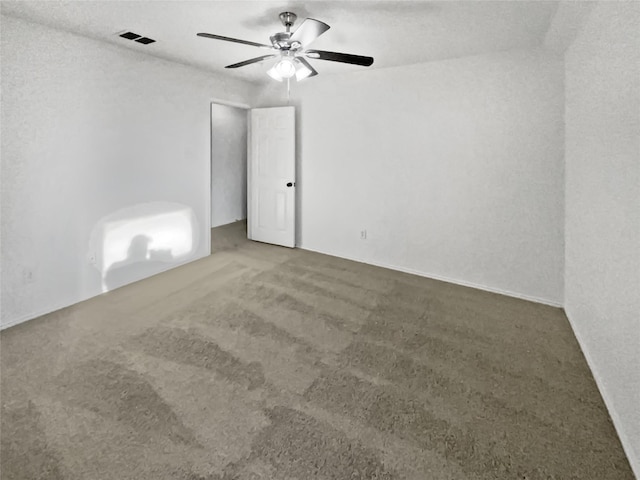 spare room featuring carpet floors and ceiling fan