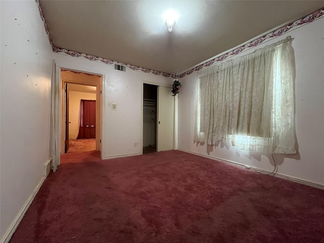 unfurnished bedroom with carpet floors and a closet