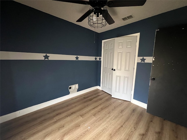 empty room with hardwood / wood-style flooring