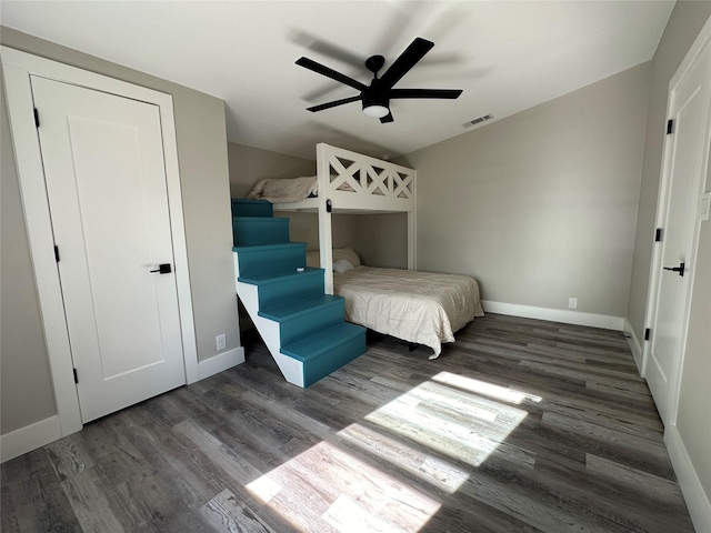 unfurnished bedroom featuring ceiling fan, dark hardwood / wood-style floors, and a closet