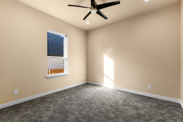 empty room featuring dark colored carpet and ceiling fan