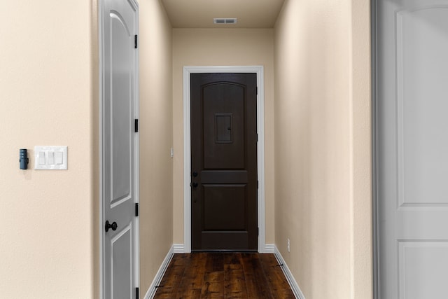 hallway with dark hardwood / wood-style floors