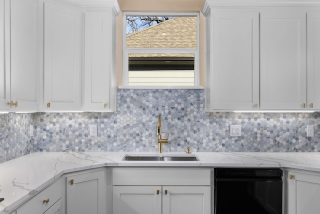 kitchen featuring sink, white cabinetry, black dishwasher, light stone countertops, and backsplash