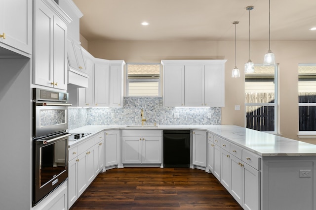 kitchen featuring sink, white cabinetry, decorative light fixtures, kitchen peninsula, and black appliances