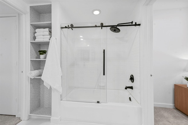 bathroom featuring bath / shower combo with glass door