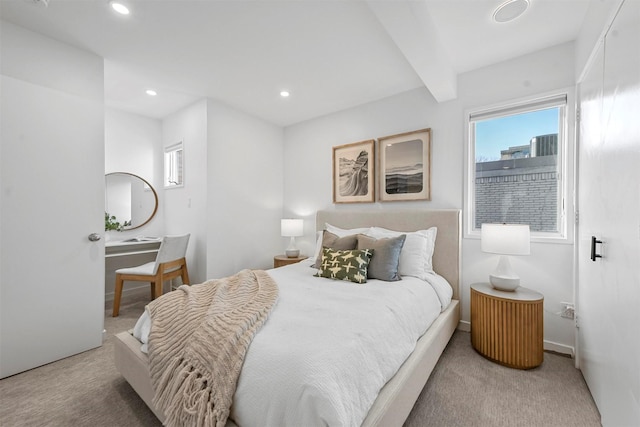 carpeted bedroom with beamed ceiling