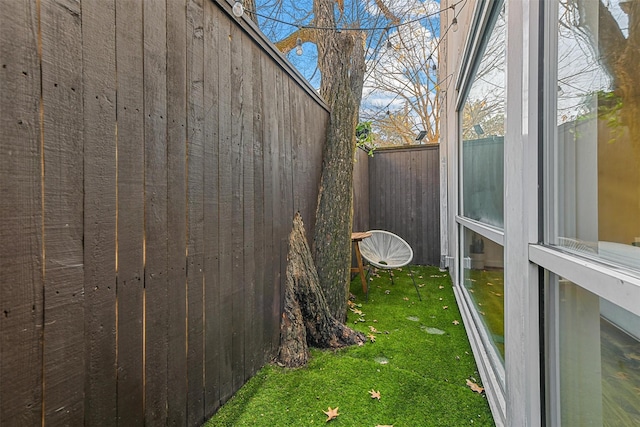 view of side of home with a yard