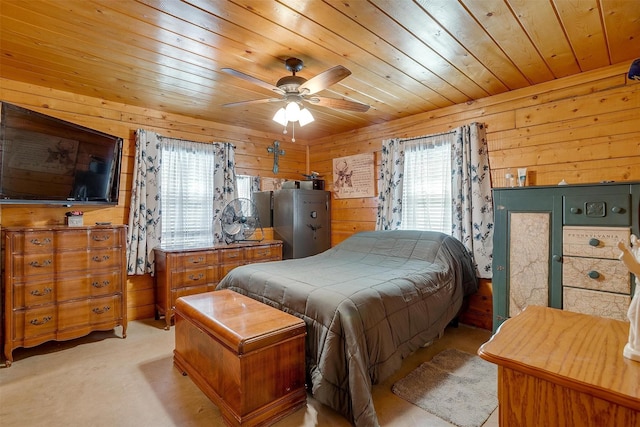 bedroom featuring light carpet, wood ceiling, wooden walls, and ceiling fan