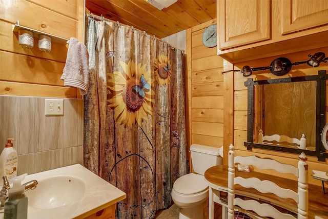 bathroom with vanity, wood ceiling, toilet, and wood walls