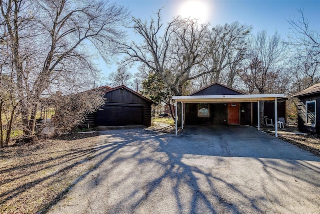 view of front facade featuring a garage and an outbuilding