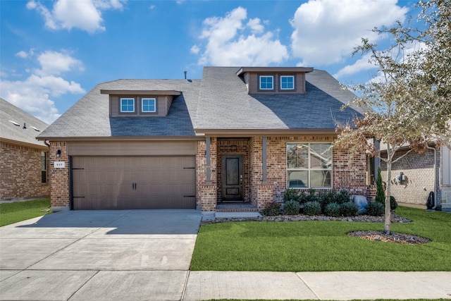 view of front of house with a garage and a front yard