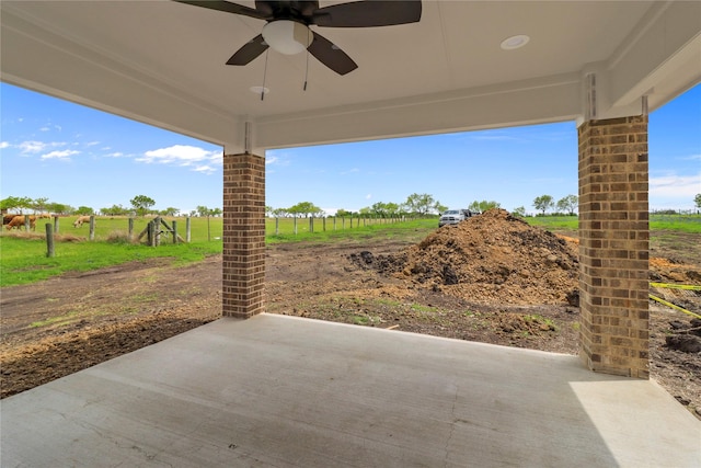 view of patio / terrace featuring a rural view and ceiling fan