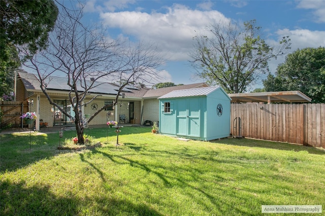 back of house featuring a lawn and a shed
