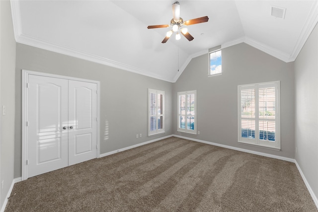 unfurnished room featuring crown molding, vaulted ceiling, carpet floors, and ceiling fan