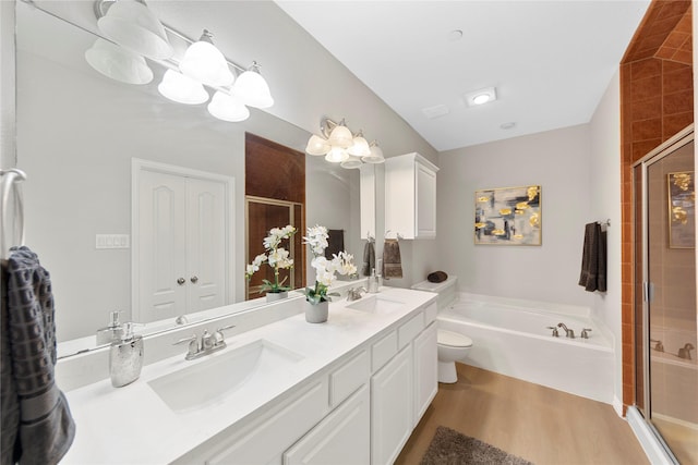 full bathroom featuring hardwood / wood-style flooring, vanity, separate shower and tub, and toilet