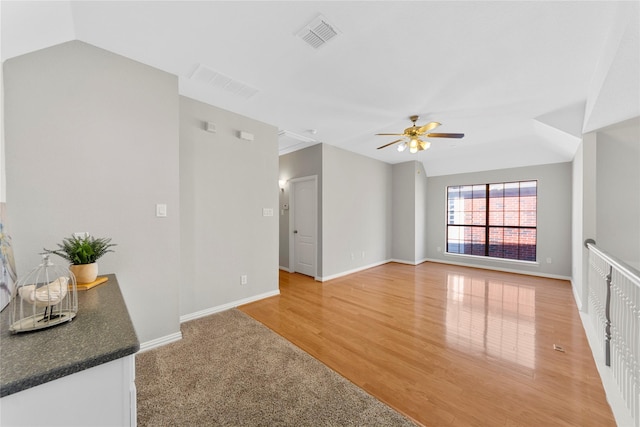 unfurnished living room featuring ceiling fan and hardwood / wood-style floors