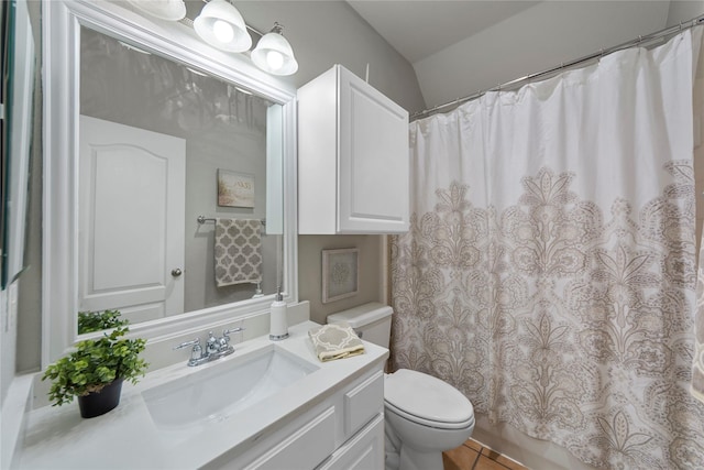 bathroom with vaulted ceiling, vanity, toilet, tile patterned floors, and a shower with shower curtain