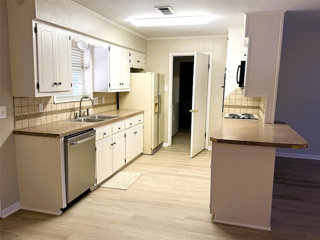 kitchen featuring crown molding, white cabinetry, stainless steel appliances, and sink