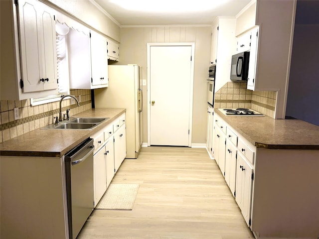 kitchen featuring sink, white cabinetry, crown molding, light wood-type flooring, and stainless steel appliances