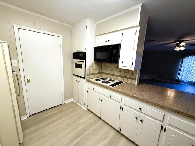 kitchen featuring crown molding, backsplash, white cabinets, and white appliances