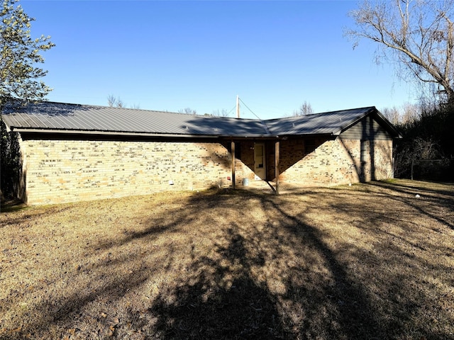 rear view of property with a lawn