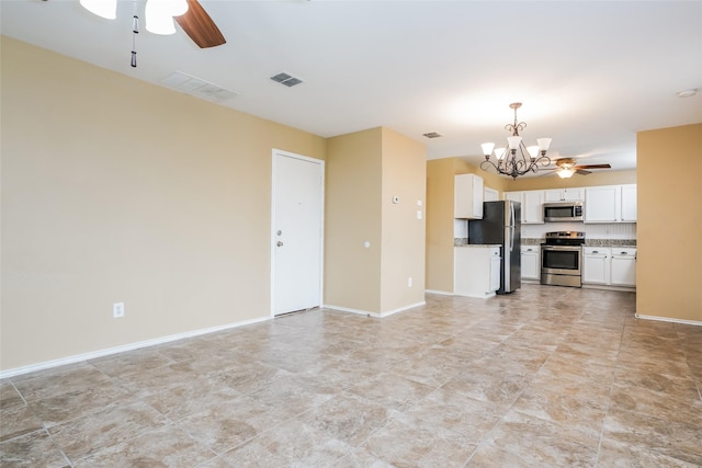 unfurnished living room with ceiling fan with notable chandelier