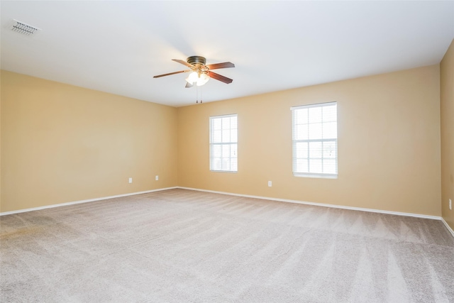 carpeted empty room featuring ceiling fan