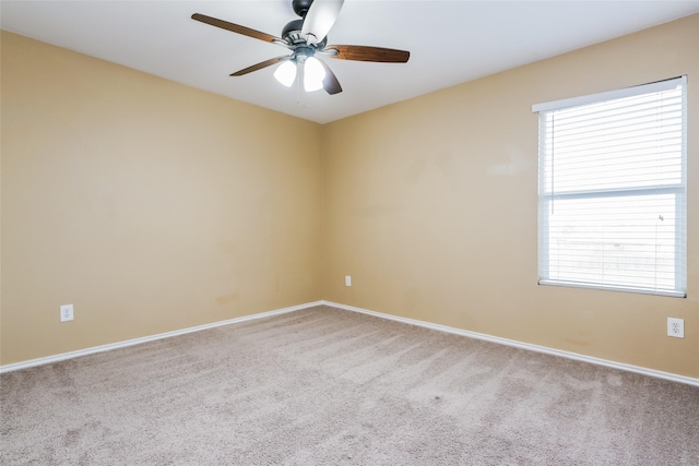 spare room with a healthy amount of sunlight, carpet floors, and ceiling fan