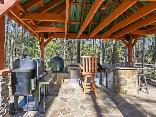 view of patio with area for grilling and an outdoor bar