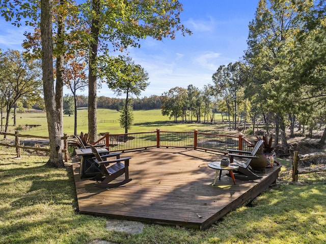 wooden deck with a rural view and a yard