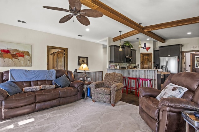 living room featuring ceiling fan, lofted ceiling with beams, and light carpet