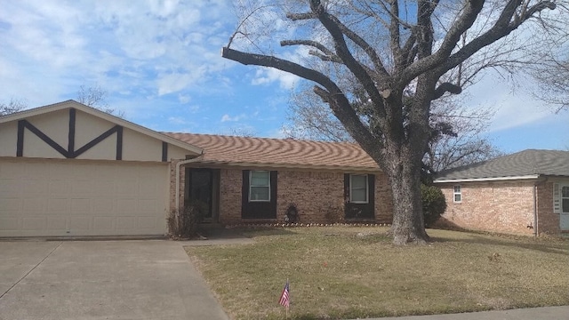 view of front of home with a garage and a front lawn