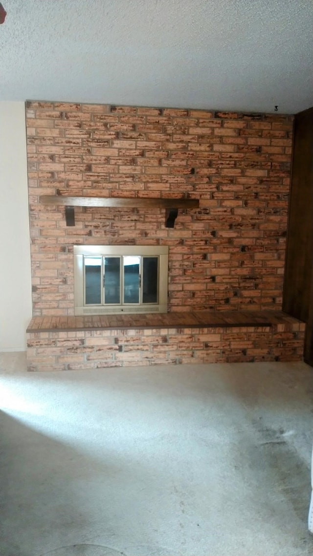 unfurnished living room with wooden walls, a textured ceiling, and carpet flooring